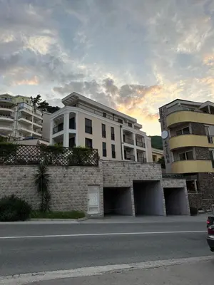 a building on the side of a road next to a building at Studio Apartman Dalia in Budva