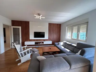 a living room with a couch and a tv at White Homes 37 • Central Point in Podgorica