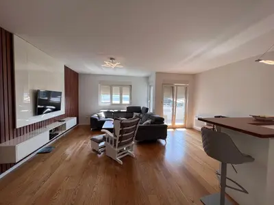 a living room with a couch and a table at White Homes 37 • Central Point in Podgorica