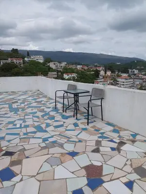 a patio with a table and chairs on a roof at Boggi Apartments in Ulcinj
