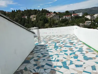 a mosaic tile floor on the side of a balcony at Boggi Apartments in Ulcinj