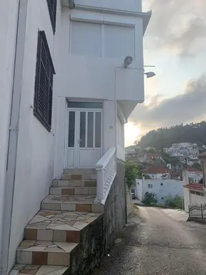 a white building with stairs and a door at Boggi Apartments in Ulcinj