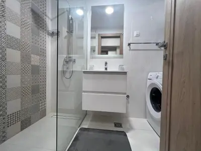 a bathroom with a sink and a washing machine at White Homes 1BR/APT•Master Quart in Podgorica