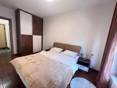 a bedroom with a large bed in a room at White Homes 1BR/APT•Master Quart in Podgorica