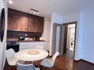 a kitchen with a table and chairs in a room at White Homes 1BR/APT•Master Quart in Podgorica