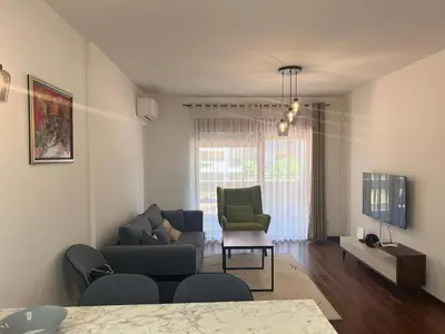 a living room with a couch and a chair at White Homes 1BR/APT•Master Quart in Podgorica