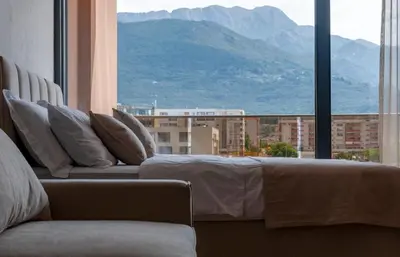 a couch in a room with a view of a mountain at Soho Suites in Bar