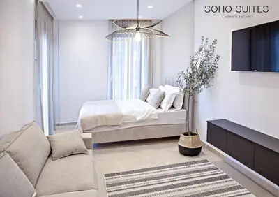 a living room with a bed and a couch at Soho Suites in Bar
