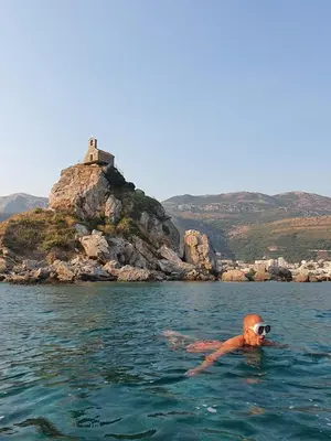 a person in the water with goggles on at Perla apartmani in Petrovac na Moru