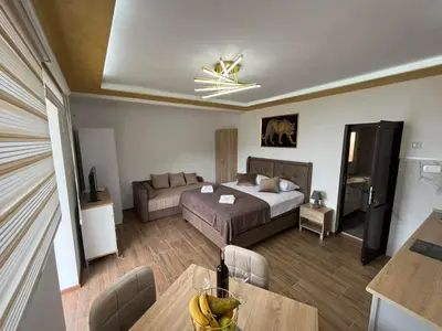 a hotel room with a bed and a dining table at Fimas Residence in Ivanovići