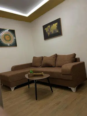 a living room with a brown couch and a table at Fimas Residence in Ivanovići
