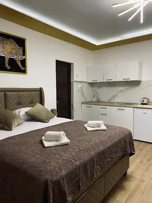 a bedroom with a bed with two towels on it at Fimas Residence in Ivanovići