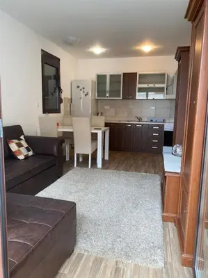 a living room with a couch and a kitchen at Apartment in Becici in Becici