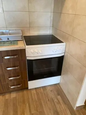 a kitchen with a black and white stove top oven at Apartment in Becici in Becici