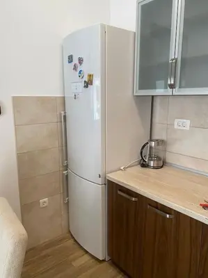 a kitchen with a white refrigerator in a room at Apartment in Becici in Becici