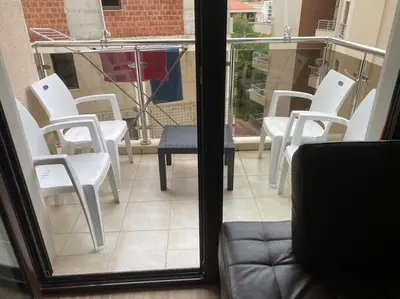 a group of white chairs sitting on a balcony at Apartment in Becici in Becici