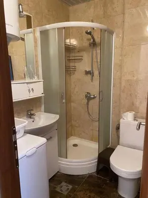 a bathroom with a shower and a toilet and a sink at Apartment in Becici in Becici