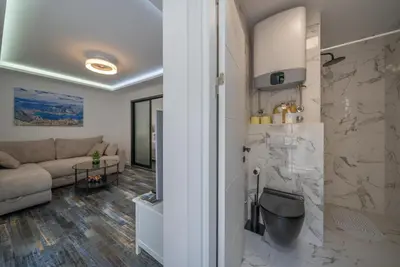 a living room with a couch and a table at Zoi apartment in Kotor