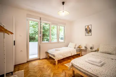 a bedroom with two beds and a window at Cozy apartment, 10 minutes walking distance from the Old Town in Kotor