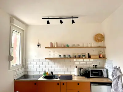 a kitchen with a sink and a microwave at Cozy apartment, 10 minutes walking distance from the Old Town in Kotor