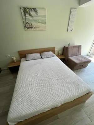a bedroom with a large bed and a couch at eagles nest in Budva