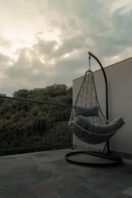 a hammock chair sitting on a balcony at eagles nest in Budva