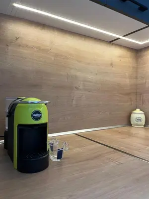 a green toaster sitting on top of a wooden floor at eagles nest in Budva