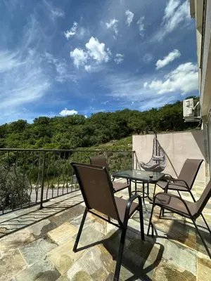 a patio with a table and chairs on a balcony at eagles nest in Budva