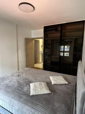 a bedroom with a bed with two pillows on it at StayPoint Apartment in Podgorica