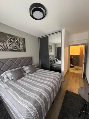 a bedroom with a large bed and a mirror at Apollo 1 in Ulcinj