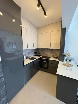 a kitchen with white and black cabinets and a counter at Apollo 1 in Ulcinj