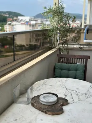 a table with a plate on top of it on a balcony at Apollo 1 in Ulcinj