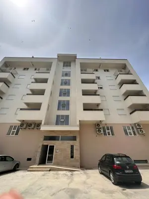 a large building with cars parked in front of it at Apollo 1 in Ulcinj