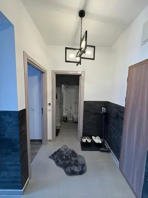 a bathroom with a chandelier and a room at Apollo 1 in Ulcinj