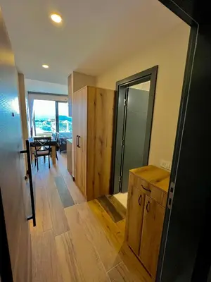a room with a mirror and a dining room with a table at Sea & Sky Apartments in Budva