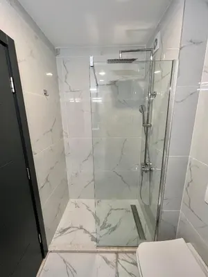 a bathroom with a shower with a glass door at Sea & Sky Apartments in Budva