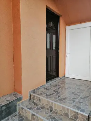 a door of a house with a stone walkway leading to it at Apartman Petovic in Kotor