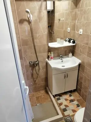 a bathroom with a sink and a shower at Apartman Petovic in Kotor