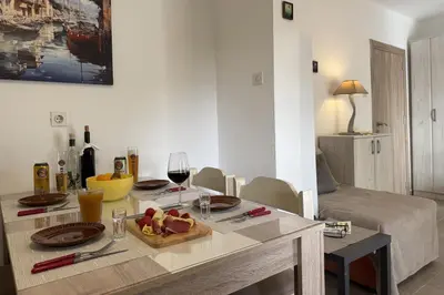 a living room with a table with food and wine glasses at Summer house Kruce in Kruče