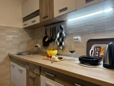 a kitchen counter with a sink and a glass of wine at Summer house Kruce in Kruče