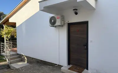 a house with a door and a speaker on the side at Summer house Kruce in Kruče