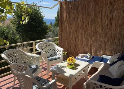 a patio with chairs and a table and a couch at Summer house Kruce in Kruče