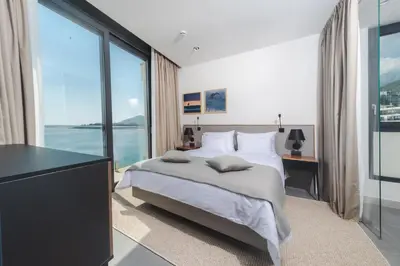 a bedroom with a bed and a large window at Boutique Hotel Shell in Budva