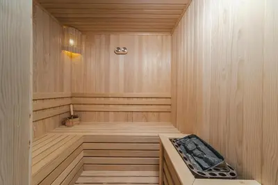 a sauna with a bench in a wooden room at Boutique Hotel Shell in Budva