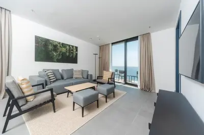 a living room with a couch and a table and chairs at Boutique Hotel Shell in Budva