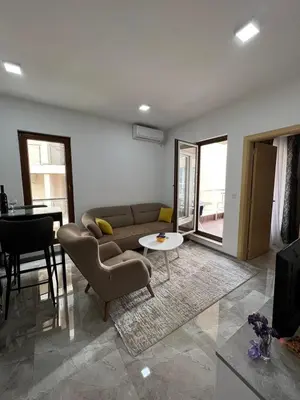 a living room with a couch and a table at Place Budva in Budva