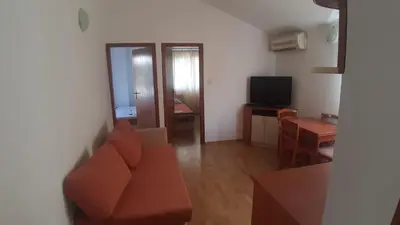 a living room with a couch and a television at Apartman Petar in Budva