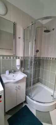 a bathroom with a shower and a sink and a tub at Apartman Petar in Budva