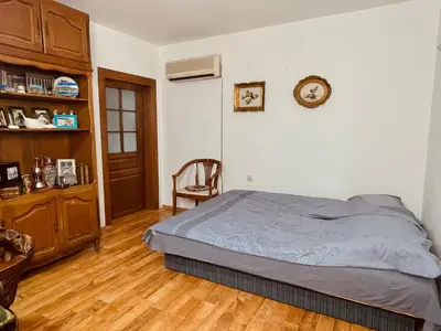 a bedroom with a bed and a clock on the wall at Village house Velimirović in Danilovgrad