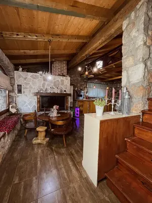 a kitchen and dining room with a stone wall at Village house Velimirović in Danilovgrad